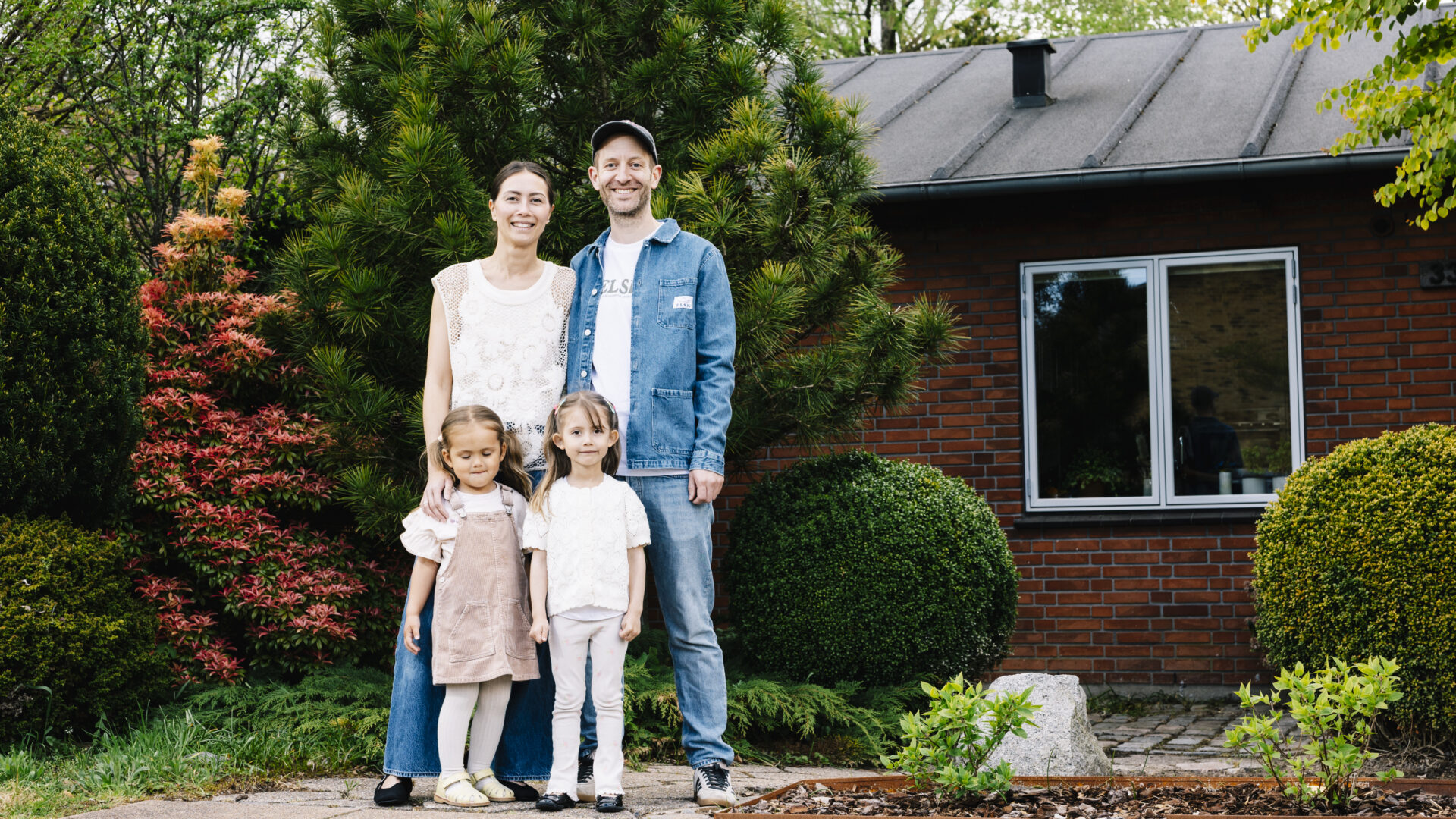 A family in front of their new home